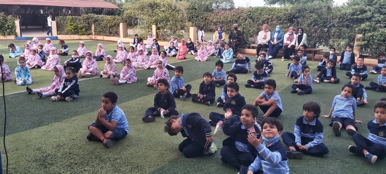 Young Helalia students sitting together on the school field